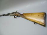 an old gun with a wooden handle on a white surface
