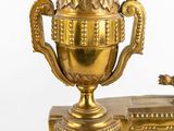 a gold trophy on a table with a bird on it