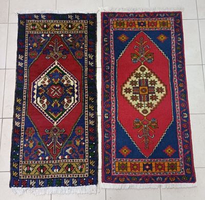 pair of oriental rugs on a tiled floor in a room