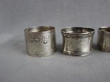 three silver napkins sitting next to each other on top of a table