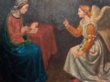 painting of an angel and a woman sitting at a table