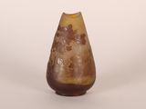 a brown vase with a yellow top on a white surface