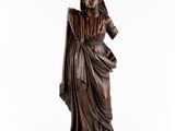 a bronze statue of a woman with a veil on her head