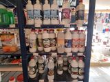 a shelf with many bottles of paint on it
