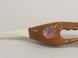 a bottle opener with a handle on a white surface
