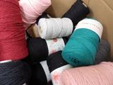 many balls of yarn in a box on the floor