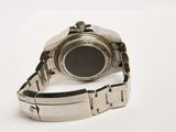 a watch that is sitting on a white surface