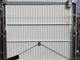 a white garage door that is open on the back of a truck
