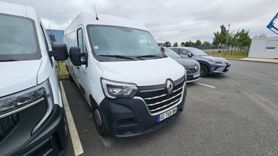 une camionnette blanche garée dans un parking à côté d'autres voitures