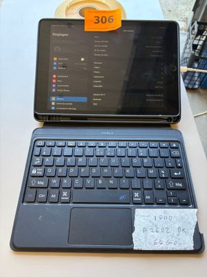 a laptop and a tablet on a table with a price tag on it