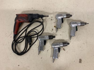 three air tools are sitting on a table next to a corded cord