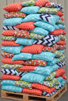 a stack of pillows sitting on top of a wooden pallet