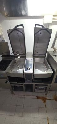 three sinks in the kitchen with a phone on them