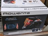 packaging of a black and orange vacuum cleaner sitting on top of a box