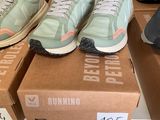 several pairs of running shoes are on a box on a table