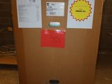 a brown box with stickers on it sitting in a room