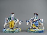 two figurines of a man and a woman riding on horses