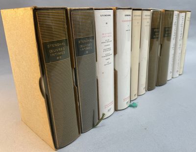 several books are lined up in a row on a table