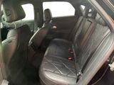 the back seats of a car with black leather seats and a red seat belt