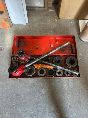 a red tool box with a wren and some other tools in it