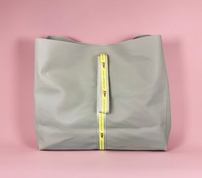 the large grey leather tote bag with a yellow zipper