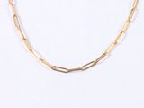 a close up of a gold chain necklace on a white background