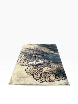 a rug with a flower design on it on a white background