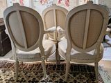 two chairs that are sitting next to each other on a rug