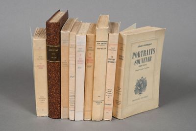 several old books are stacked on top of each other on a table