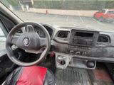 steering wheel and dashboard of a car with a red bag in the passenger seat