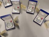 a lot of silver coins on a white table