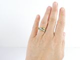 a woman ' s hand with a ring on it
