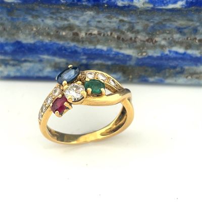a close up of a gold ring with multi colored stones