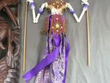 a figurine of a woman holding a staff next to a statue of a man