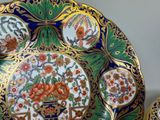 a plate with flowers and birds on it on a table