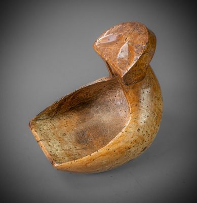 an image of a wooden bowl with a stone in the shape of a duck