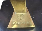 a gold trophy sitting on top of a black table
