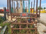 a fence that has a bunch of rusted metal bars on it