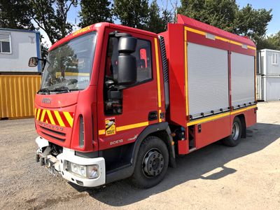 a red fire truck that is parked in a lot