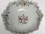 a white bowl with a floral design on it