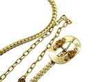 a gold chain with a brooch and a gold chain with a brooch and a gold chain with a brooch and a gold chain with a bro