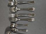five spoons and a fork on a table