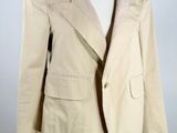 an image of a beige jacket on a mannequin