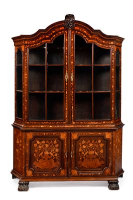 an antique wooden cabinet with glass doors and carvings on the front