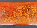 an orange box with a painting on it sitting on a table