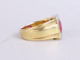 yellow gold ring with a pink stone on a white surface