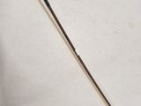 a close up of a small metal object on a white surface