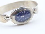 an image of a silver bracelet with a blue dial on it