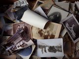 a pile of old photos that are on a table