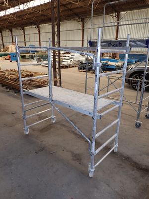 scaffolding in a warehouse with a lot of wood and metal